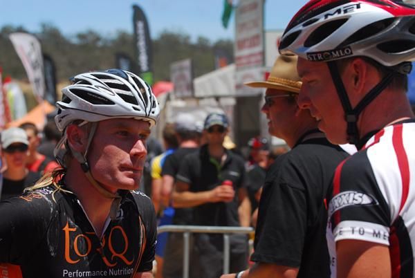 Daniel McConnell shows signs of a hard race when talking to Ben Henderson after the race.
