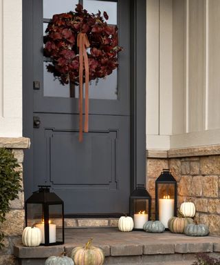 mcgee and co fall front door porch decor with wreath and pumpkins and lanterns