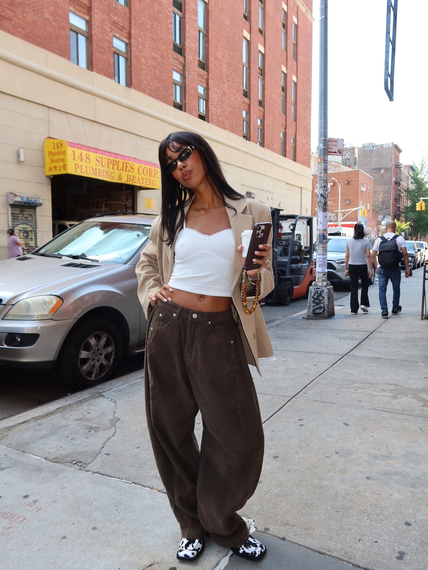 Woman wearing barrel-leg brown corduroy pants.