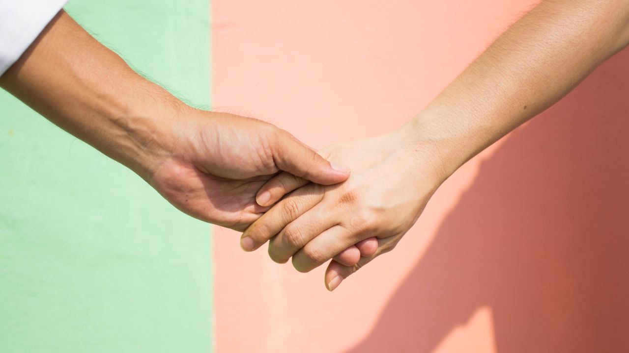 Cropped Hand Against Wall - stock photo.