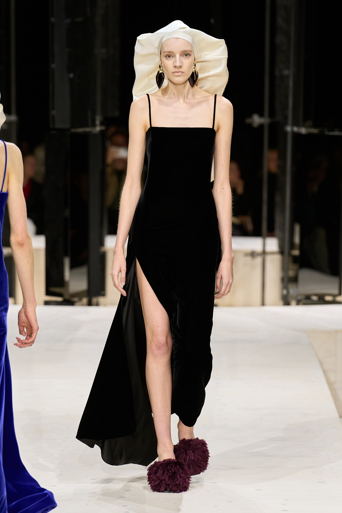 a model wears a headcovering on the givenchy f/w 26 runway.