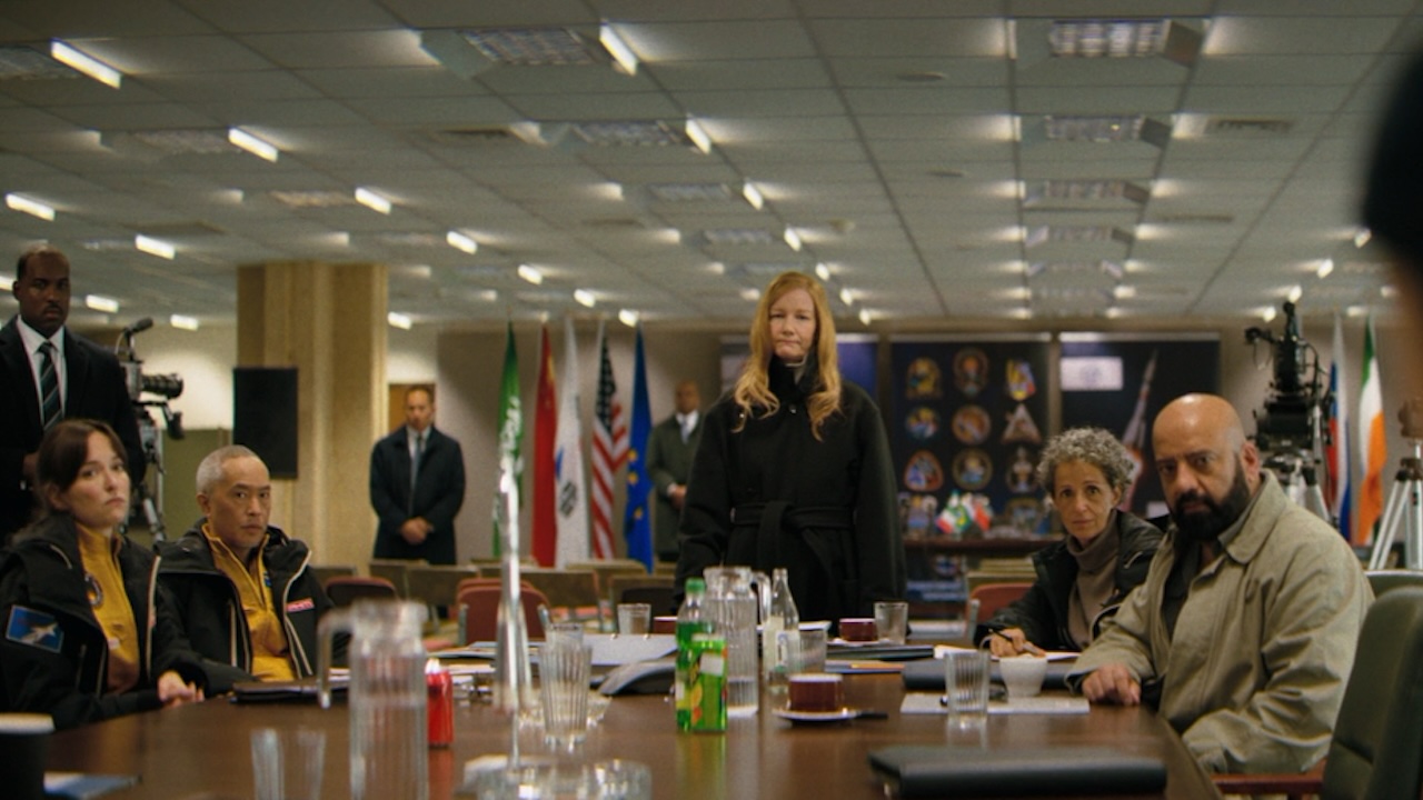 Stratt standing with the astronauts at a table in Project Hail Mary