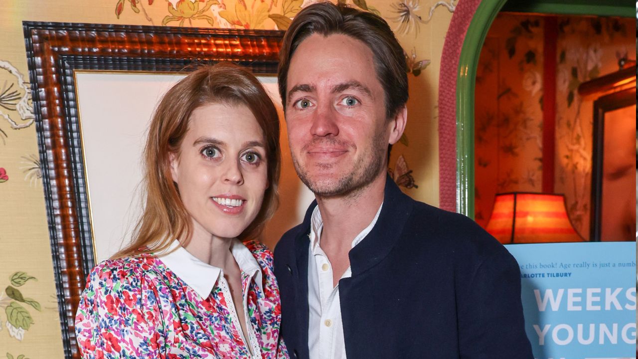 Princess Beatrice wearing a floral dress smiling and standing next to Edoardo Mapelli Mozzi 