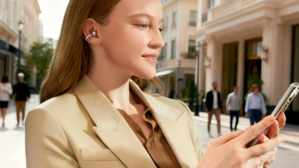 The Honor Choice Earbuds Clip 2 being worn by a woman who's also using an Honor phone.