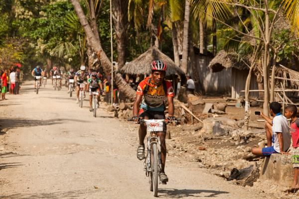 Racers go through a small village