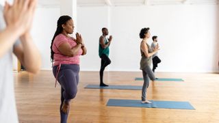 Group of women doing Pilates workout at a studio with ankle weights