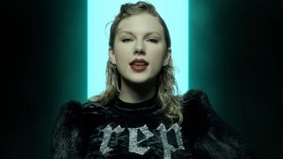 Taylor Swift wearing a top that says "Rep" in the "Look What You Made Me Do" music video.