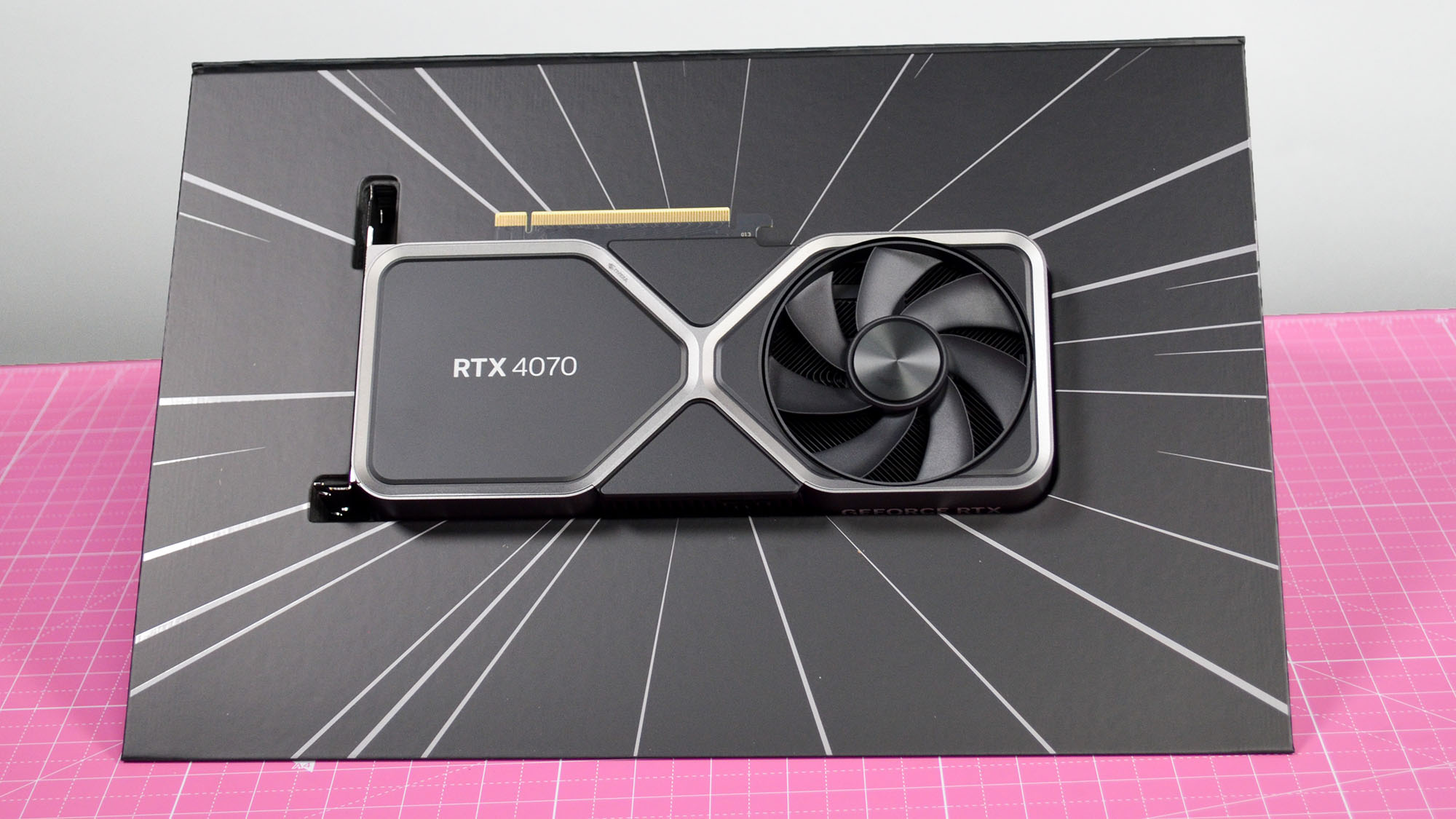 An Nvidia GeForce RTX 4070 graphics card seated inside its retail packaging