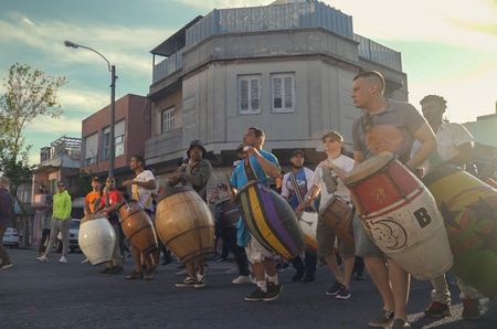 Scene from a carnival: men carrying colourful drums