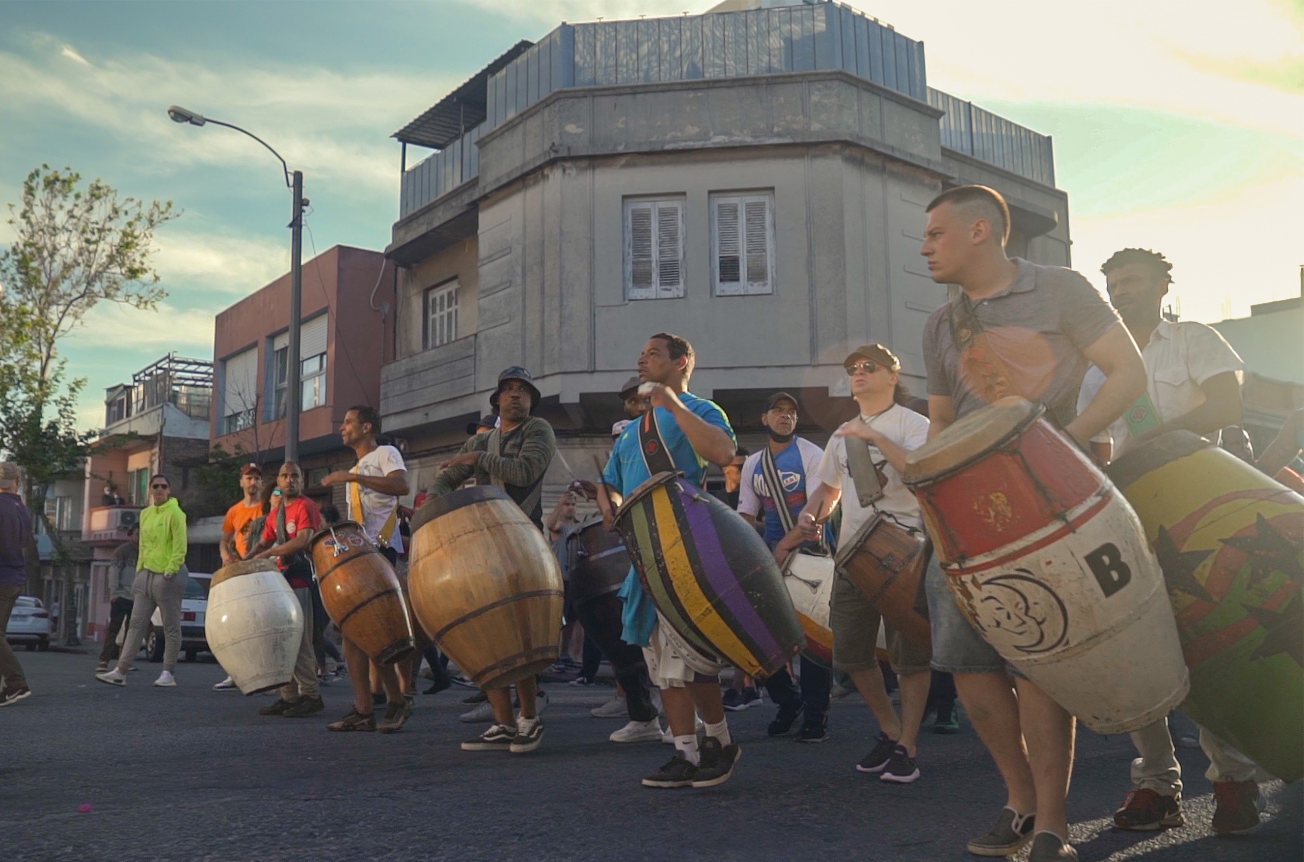 Scene from a carnival: men carrying colourful drums