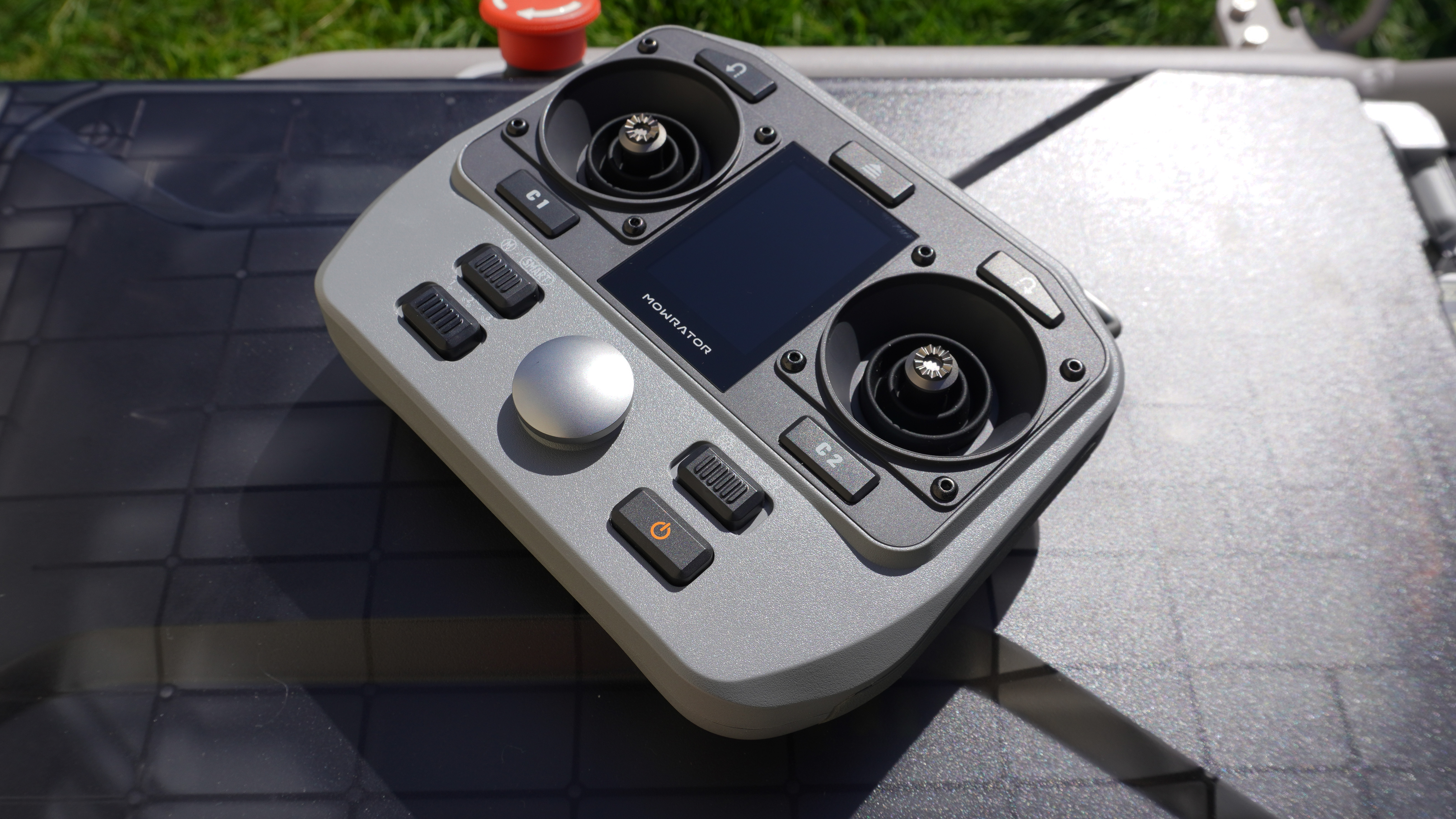 Controller of the Mowrator S1 2WD lawnmower on top of the battery compartment.