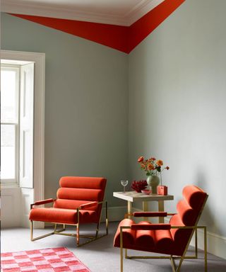 Living room in Smokey Green by Benjamin Moore with coving detail in Outrageous Orange