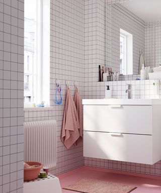 Small bathroom with white tiles and pink floor