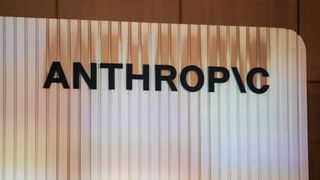 A white striped sign holds the word "Anthropic" on it with the i being a backslash. The shadows from the letters show on the white sign. 