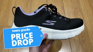 Skechers GO RUN Lite held in woman's hand