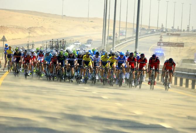 The peloton tries to hide from the wind and sand during the Dubai Tour