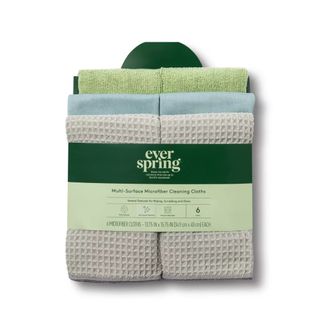 A pack of gray, green, and blue microfiber cloths with a dark green label wrapped around them