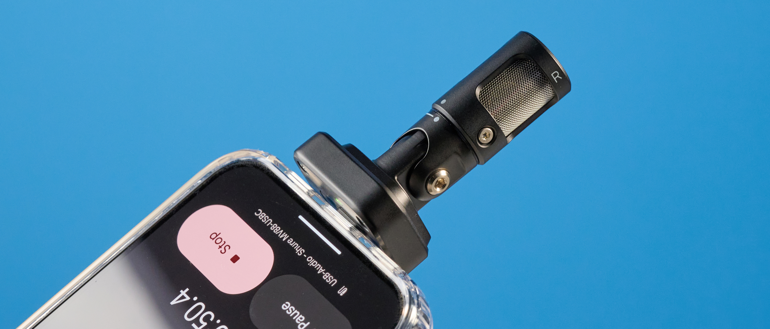 the shure mv88 usb-c microphone photographed against a blue tom's guide background and shown connected to a google pixel 10 pro