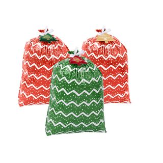 Two red and one green oversized Christmas grab bags with a white zig zag and dotty pattern