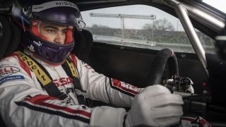 A screenshot of Archie Madekwe's Jann Mardenborough driving a racing car in the Gran Turismo movie