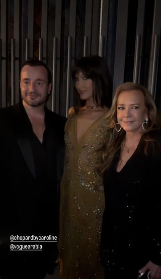 Bella Hadid stands with executives of Vogue Arabia at a Chopard store opening