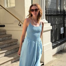 Woman wears blue shirred dress
