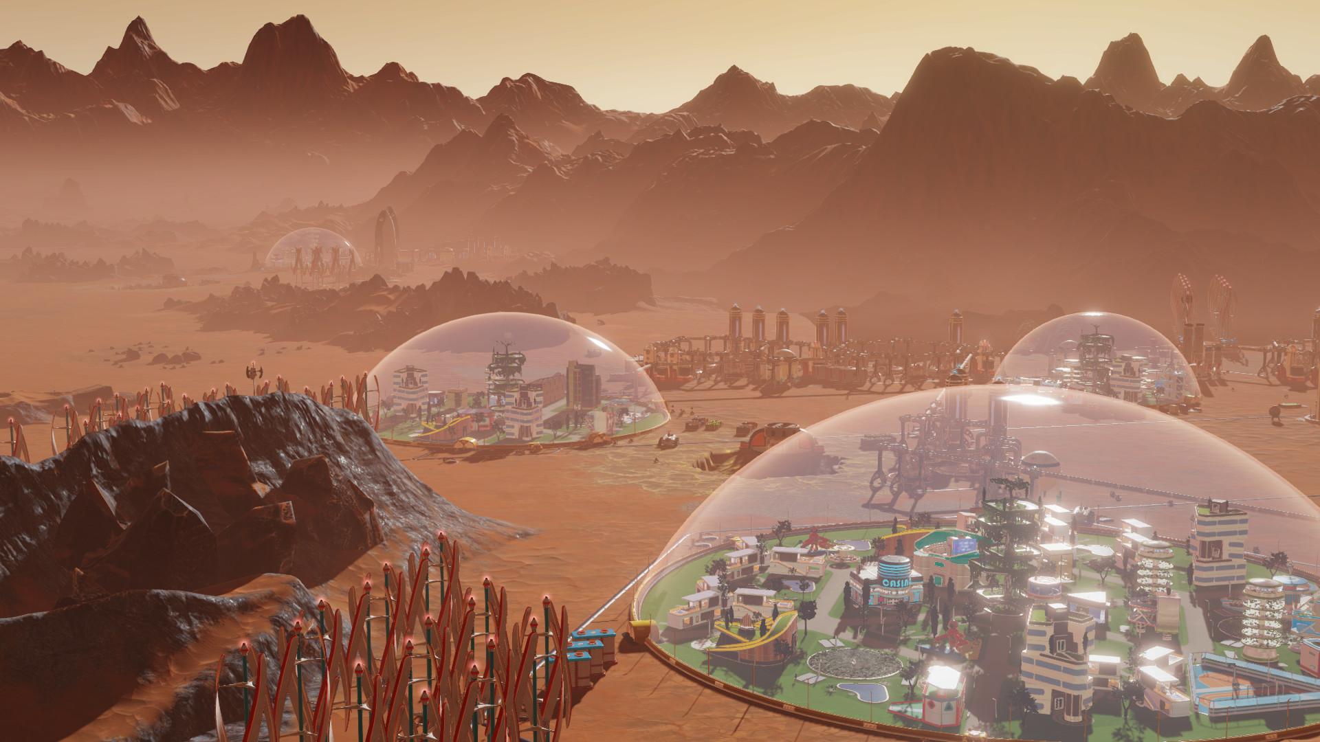 Uma captura de tela da Haemimont Games e Abstraction's Surviving Mars, mostrando cúpulas de vidro cheias de edifícios na superfície de Marte.