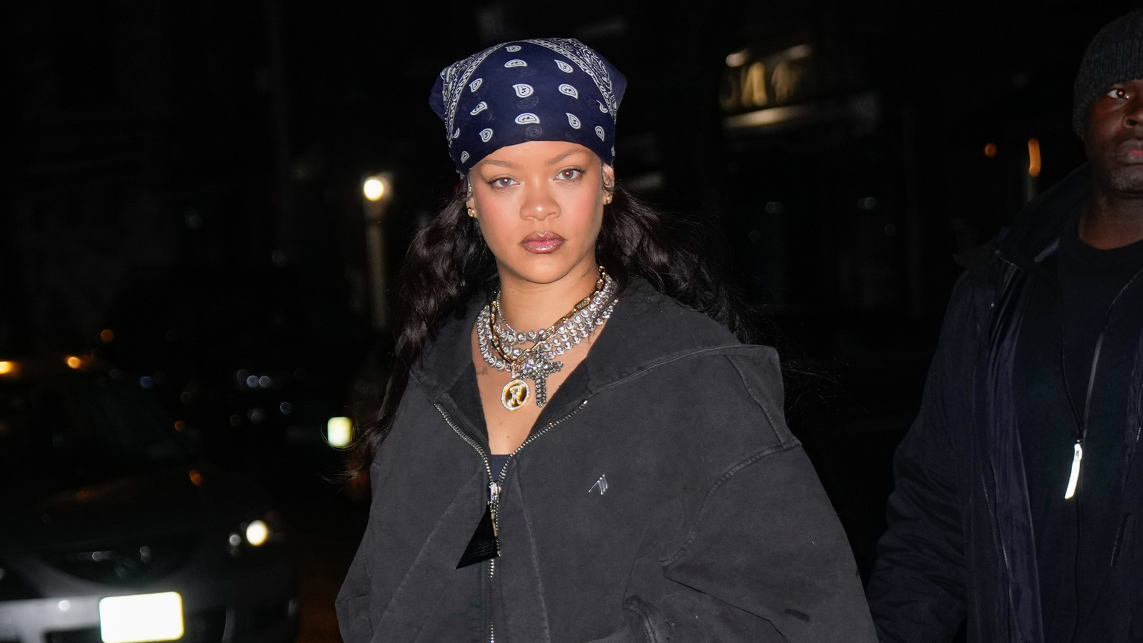 Rihanna wearing a headscarf and multiple necklaces.