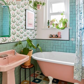 Retro style pink and green bathroom with pink bathtub and pink sink