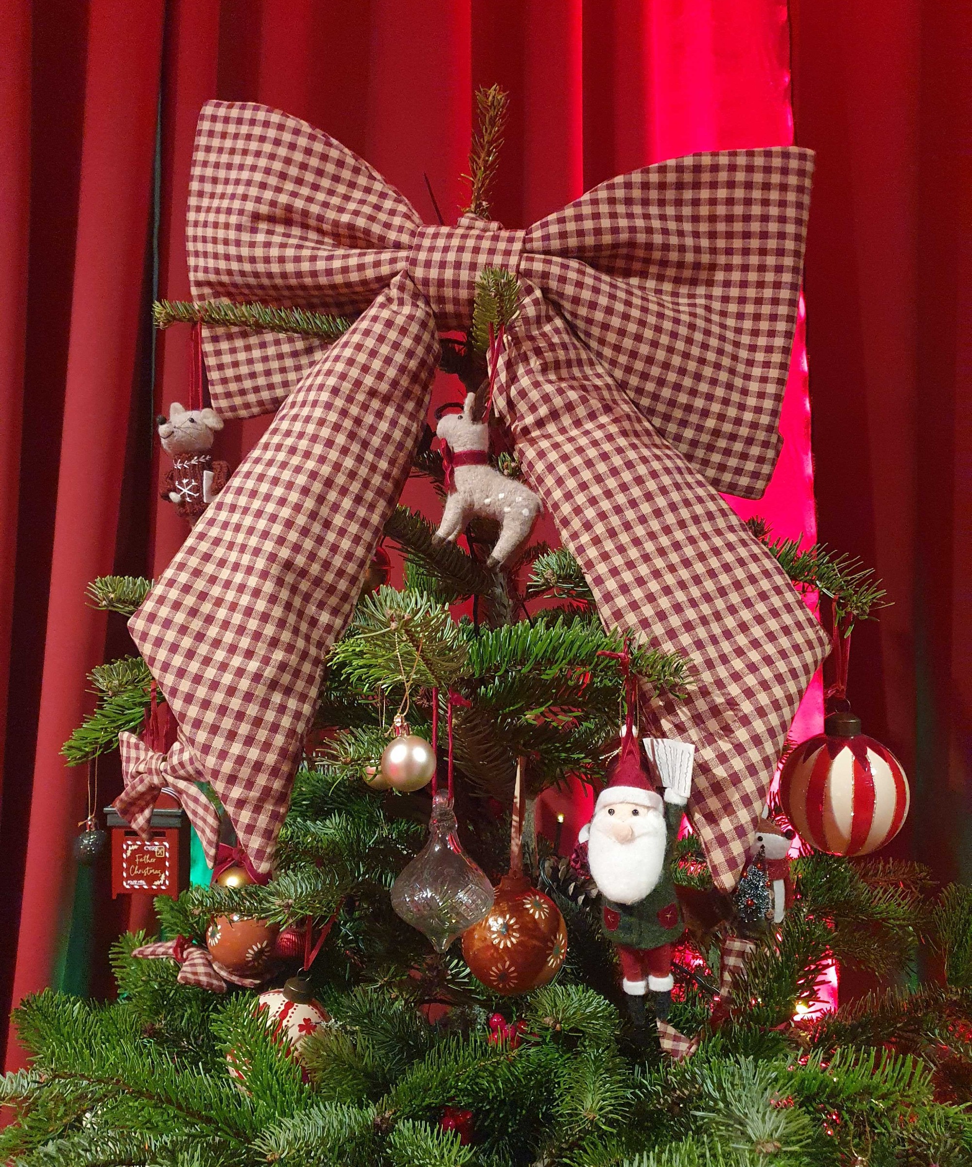 Marks &amp;amp; Spencer's large gingham Christmas bow used as a tree topper at the brand's autumn/winter 2026 press preview