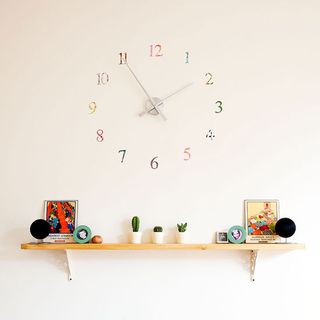 kitchen with watch on wall and frame and potted plant