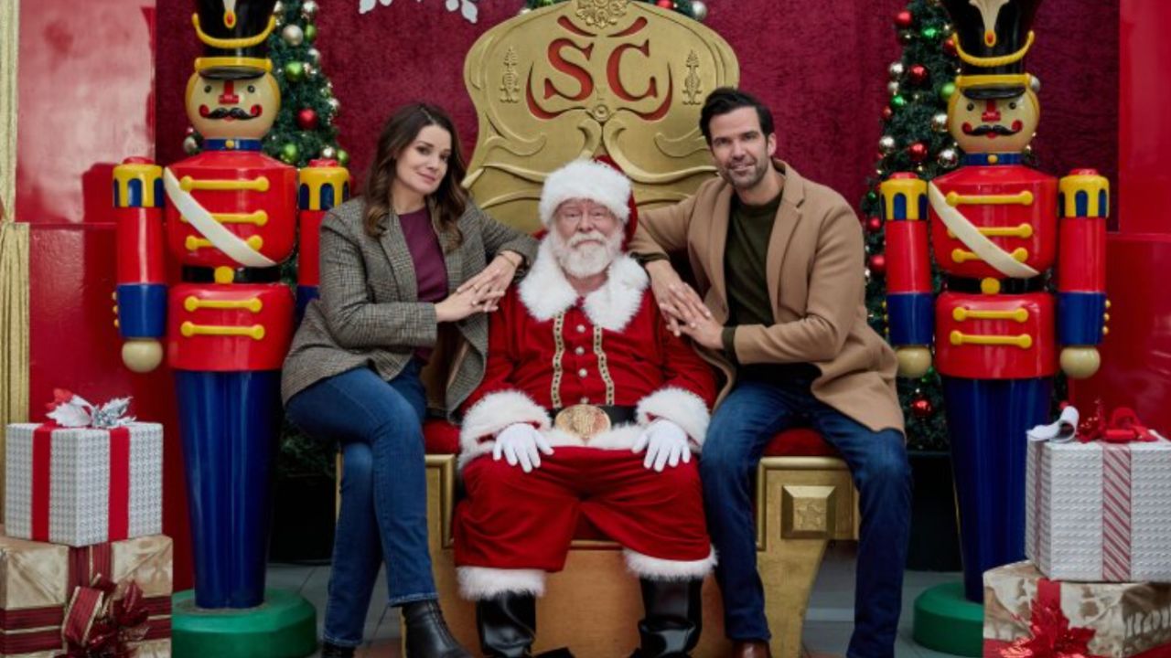 Kimberly Sustad and Benjamin Ayres sitting on Santa's lap at a Mall Santa display