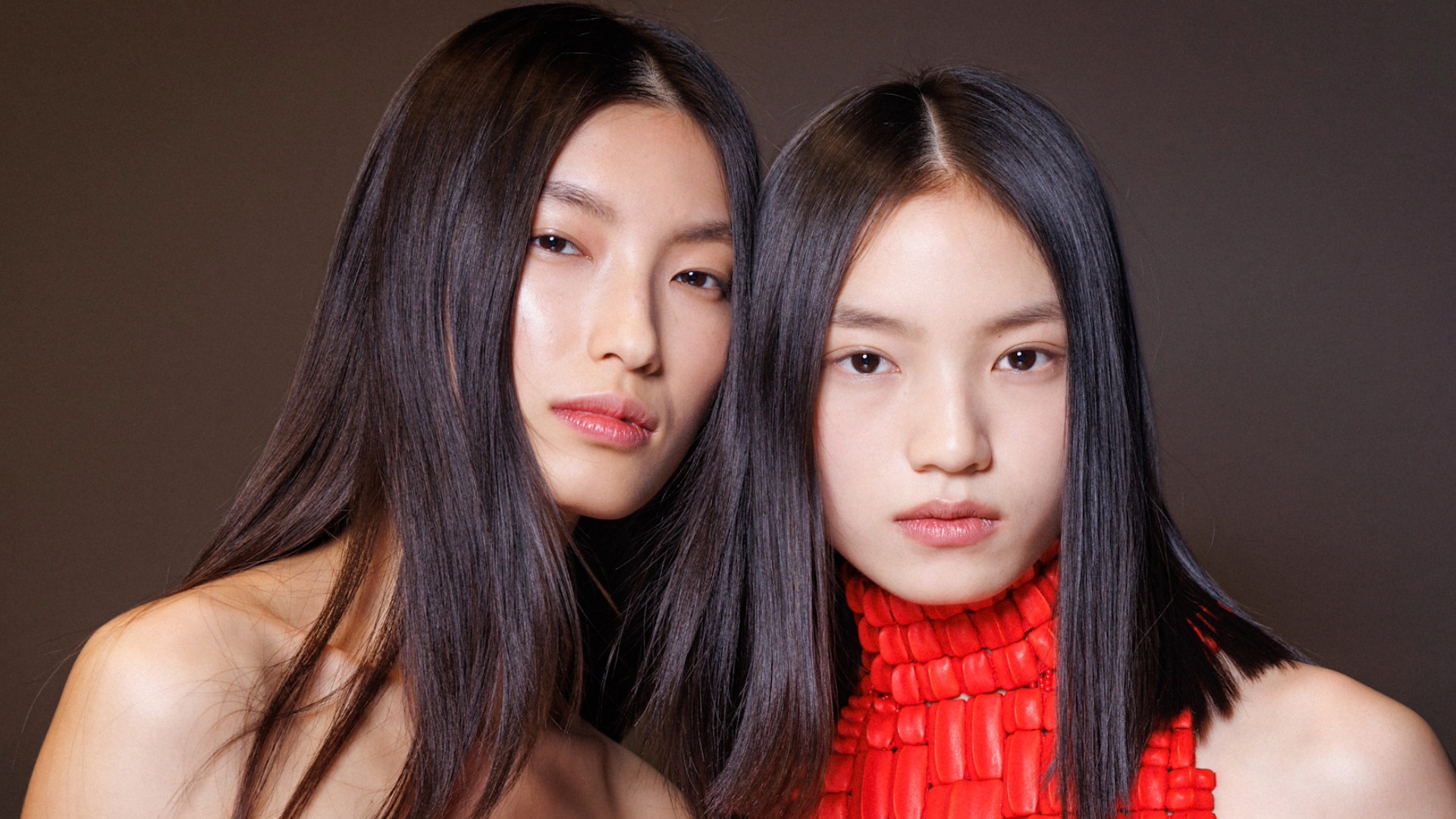 women with shiny black hair backstage at the Balmain fashion show at Paris Fashion Week.