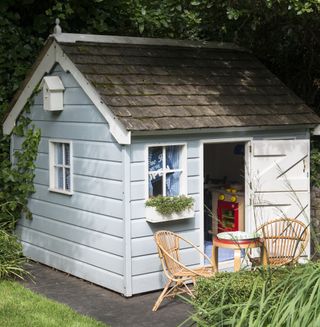 wendy house with cane chair and table