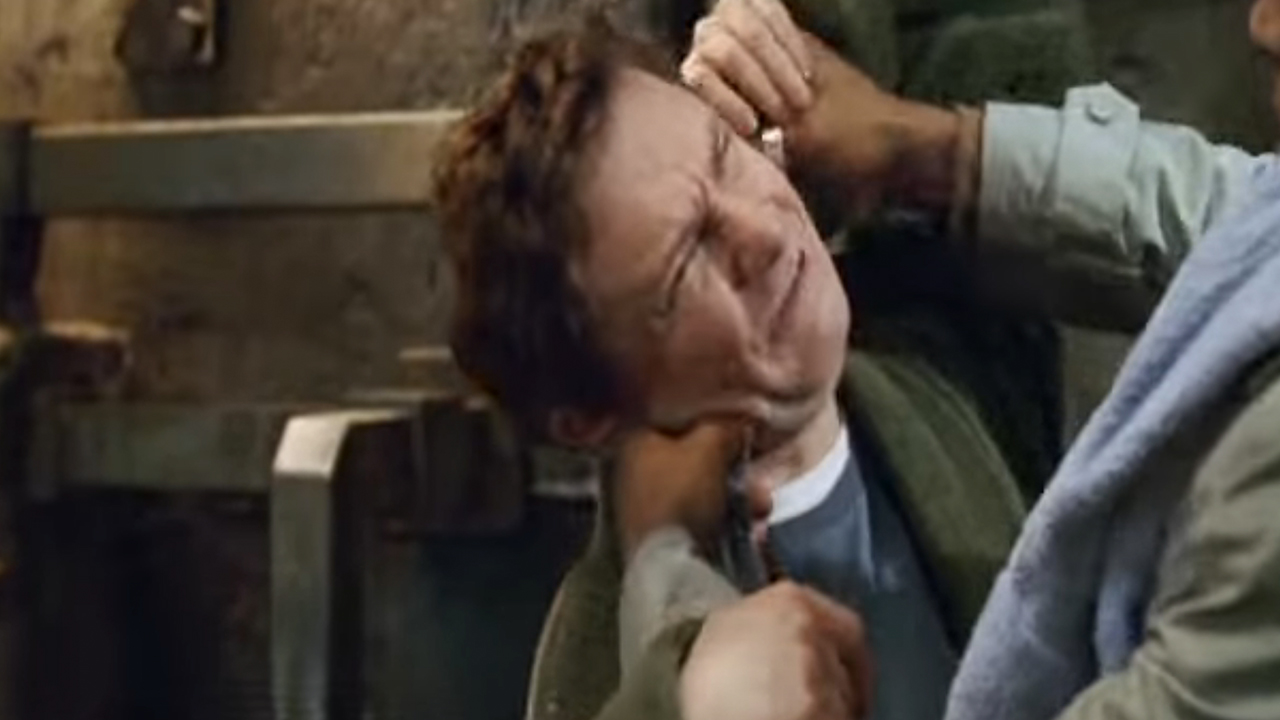 Martin Freeman looking upset as someone puts something in his ear in The Hitchhiker&#039;s Guide To The Galaxy