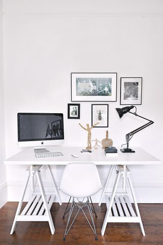 All white home office with small gallery wall