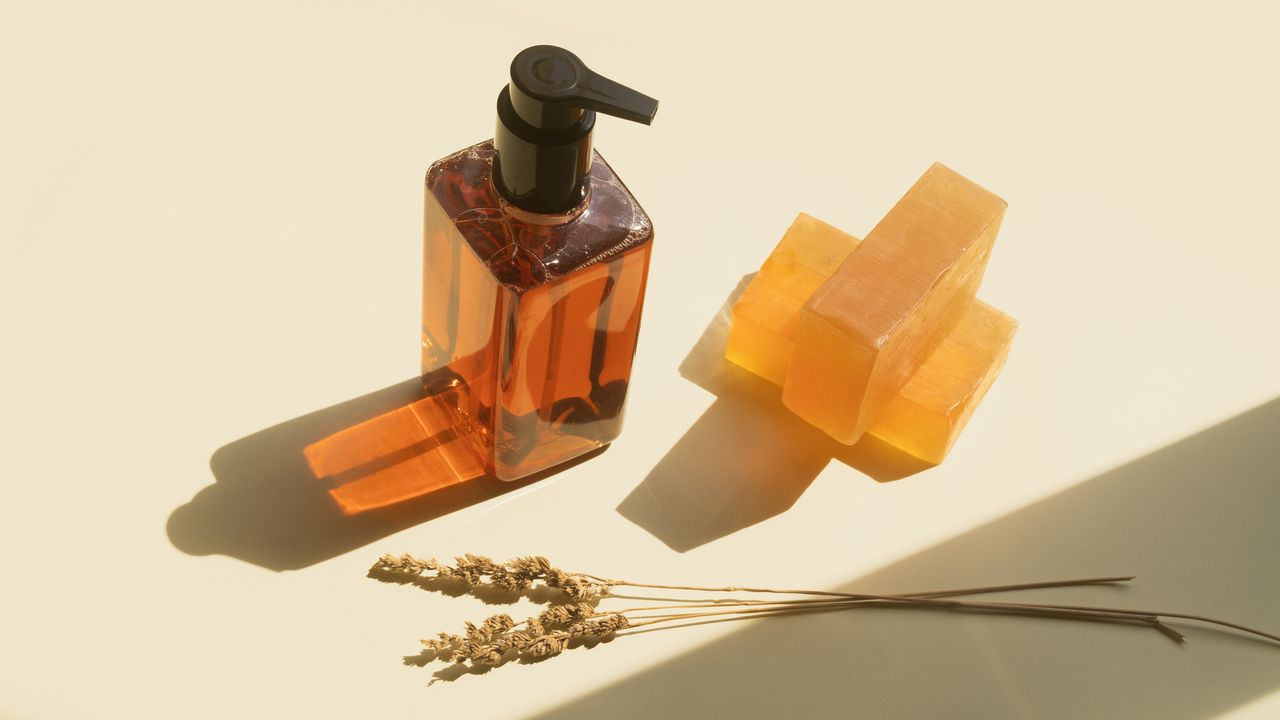 A bar of soap and cleansing bottle on a bathroom counter