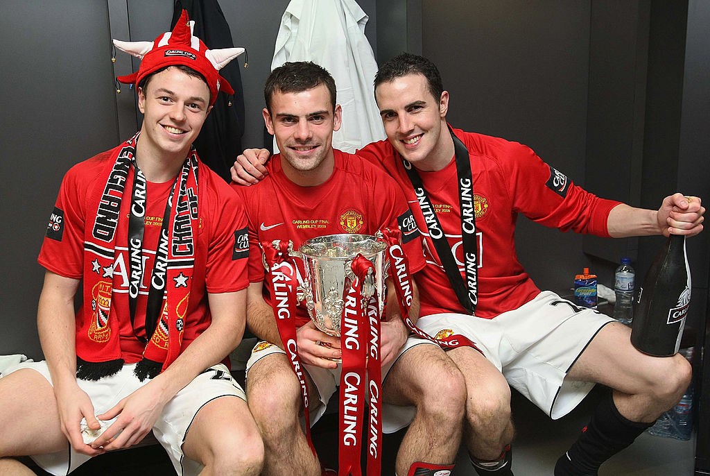 LONDON, ENGLAND - MARCH 1: Jonny Evans, Darron Gibson and John O'Shea of Manchester United pose in the dressing room with the Carling Cup trophy after the Carling Cup Final match between Manchester United and Tottenham Hotspur at Wembley Stadium on March 1 2009 in London, England. (Photo by John Peters/Manchester United via Getty Images)