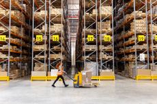 worker pushing a truck in a warehouse
