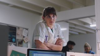 Jodie Whyte in 2020 as a student midwife in a white uniform with green trim.