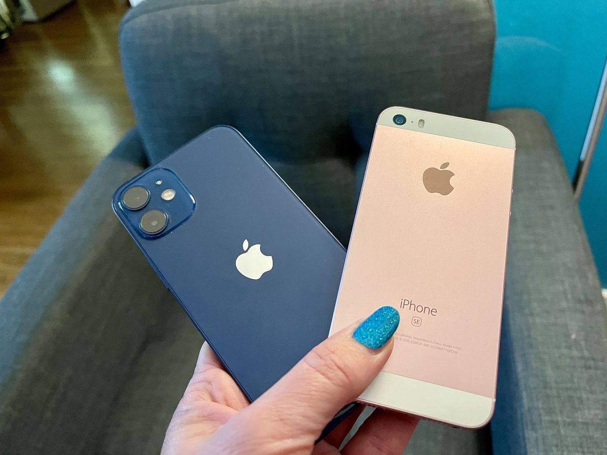 iPhone 12 mini and original iPhone SE side-by-side in a hand