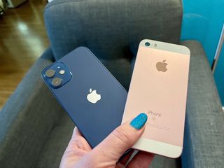 iPhone 12 mini and original iPhone SE side-by-side in a hand
