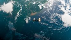 image showing the international space station orbiting above the ocean