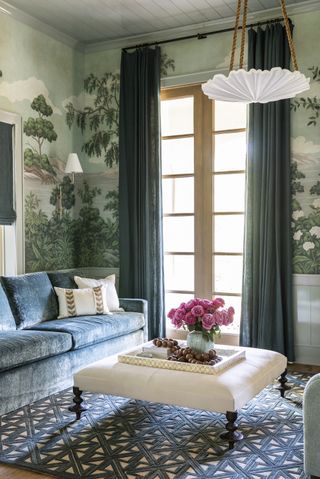 green living room with botanical wallpaper and blue sofas by Marie Flanigan