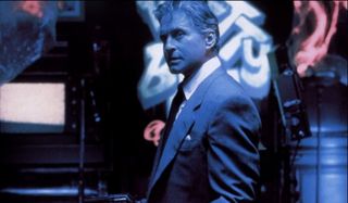 The Game Michael Douglas bathed in blue light, holding a gun