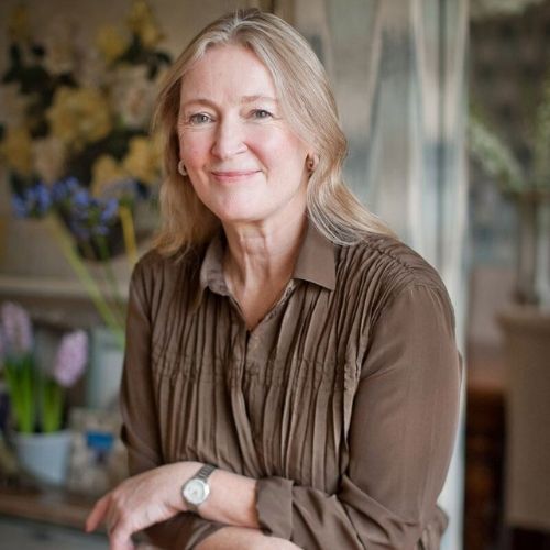 Image of a woman in a brown blouse.