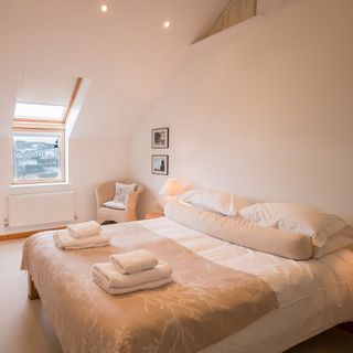 bedroom with white wall and glass window