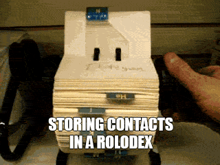 A hand is seen flipping quickly through a Rolodex.
