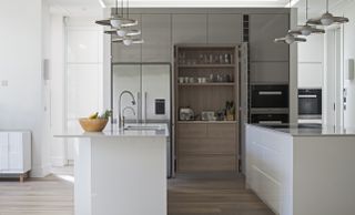 Kitchen with facing kitchen islands and pendant lights over each