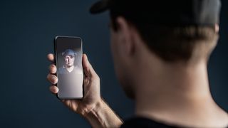 Man using face recognition with facial scan in phone